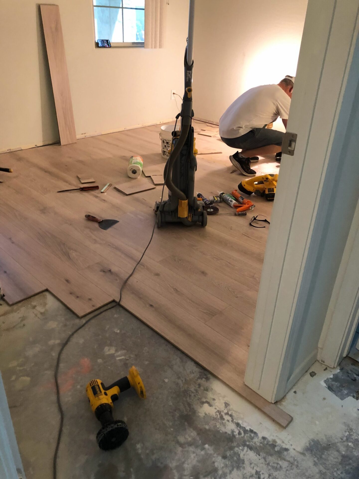 Guest bedroom DIY flooring installation DURING at snowbird sanctuary - Hello Lovely Studio.