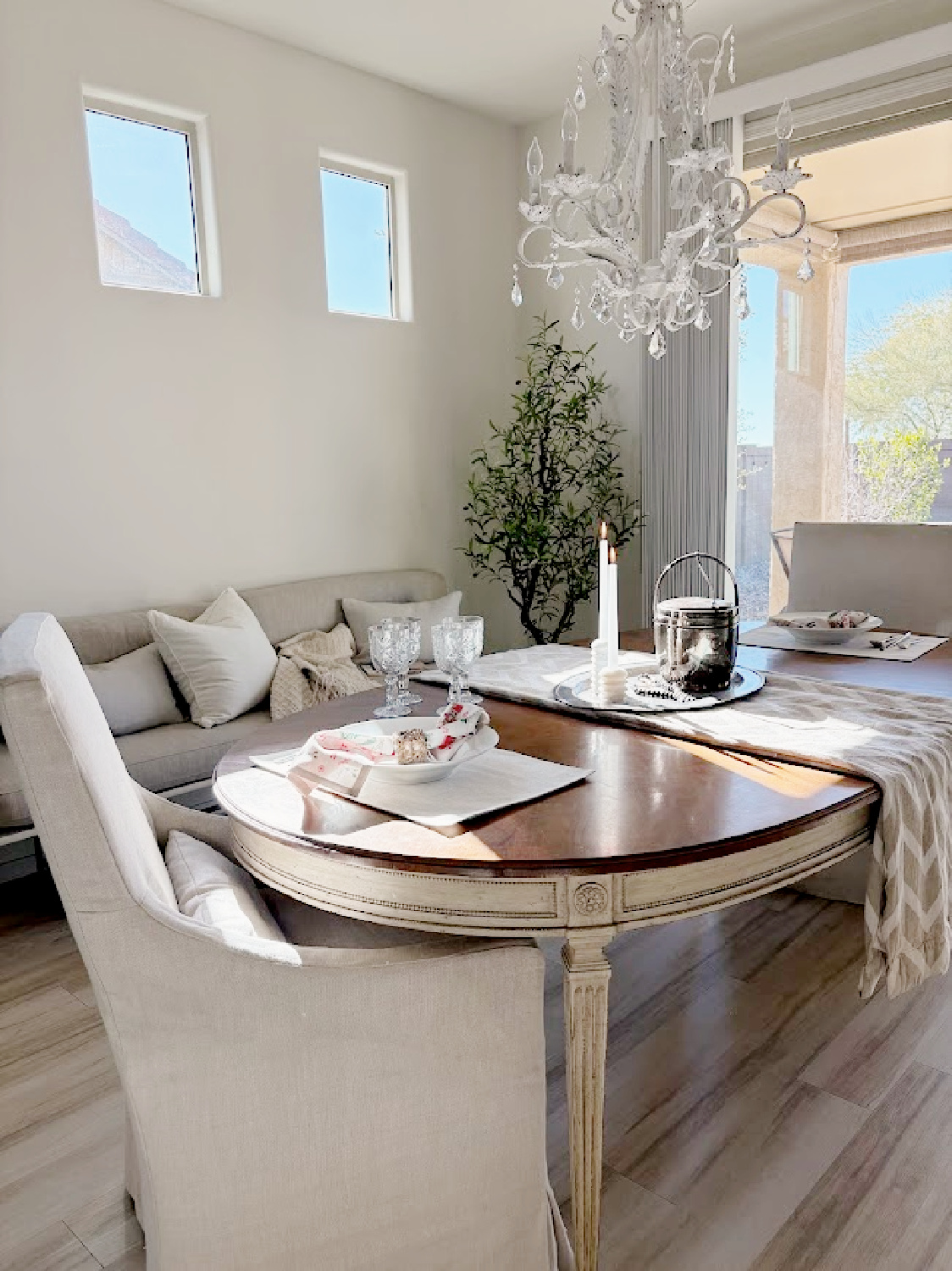 I placed a rather large oval dining table in a smallish dining area in our snowbird Arizona home and the space actually feels larger now - Hello Lovely.