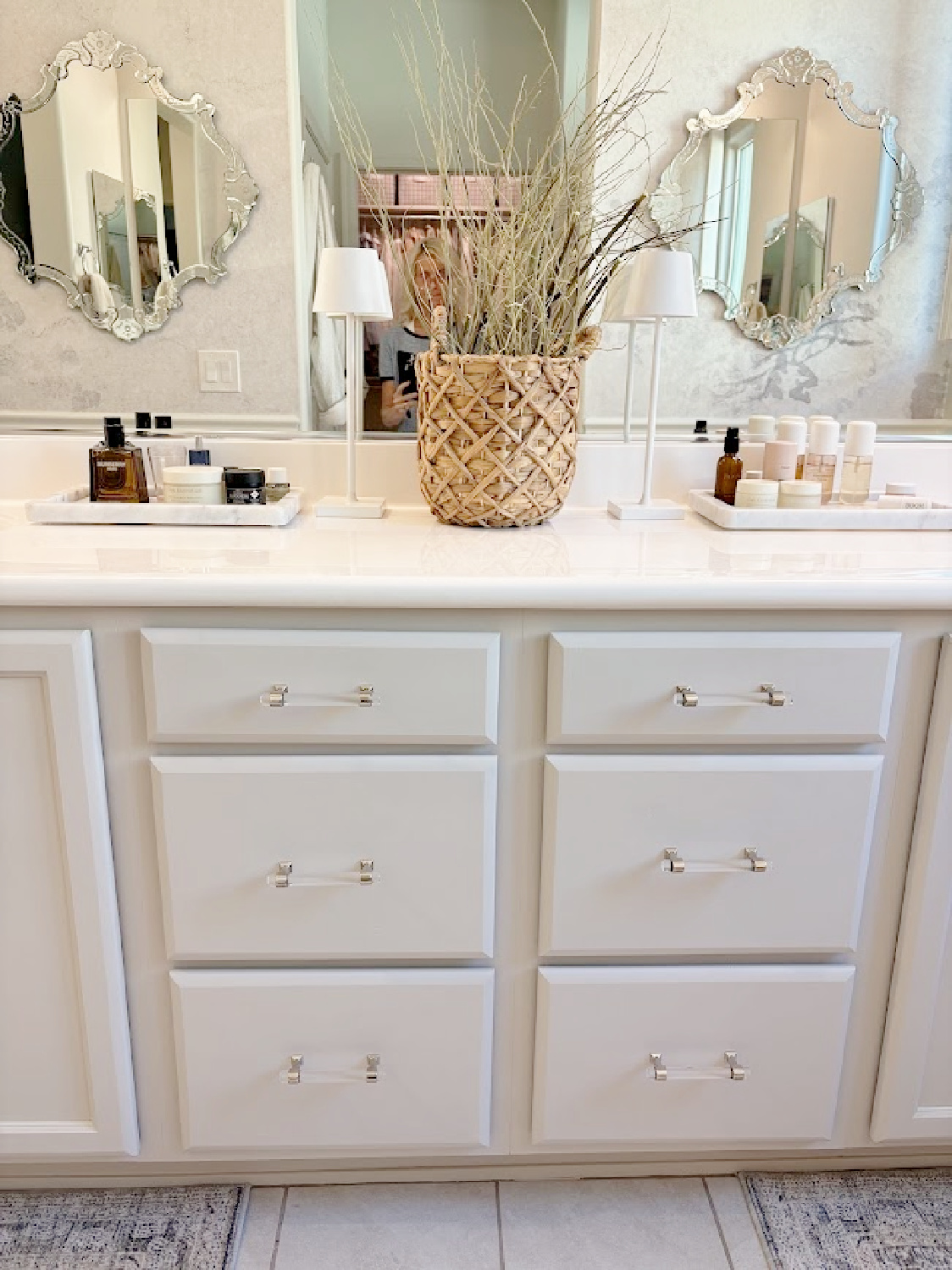 Our renovated bath at the snowbird Arizona house with SW Agreeable Gray painted vanity, lucite hardware, Venetian mirrors layered on a Photowall mural wallpaper, and rugs from Loloi x Amber Lewis - Hello Lovely Studio.