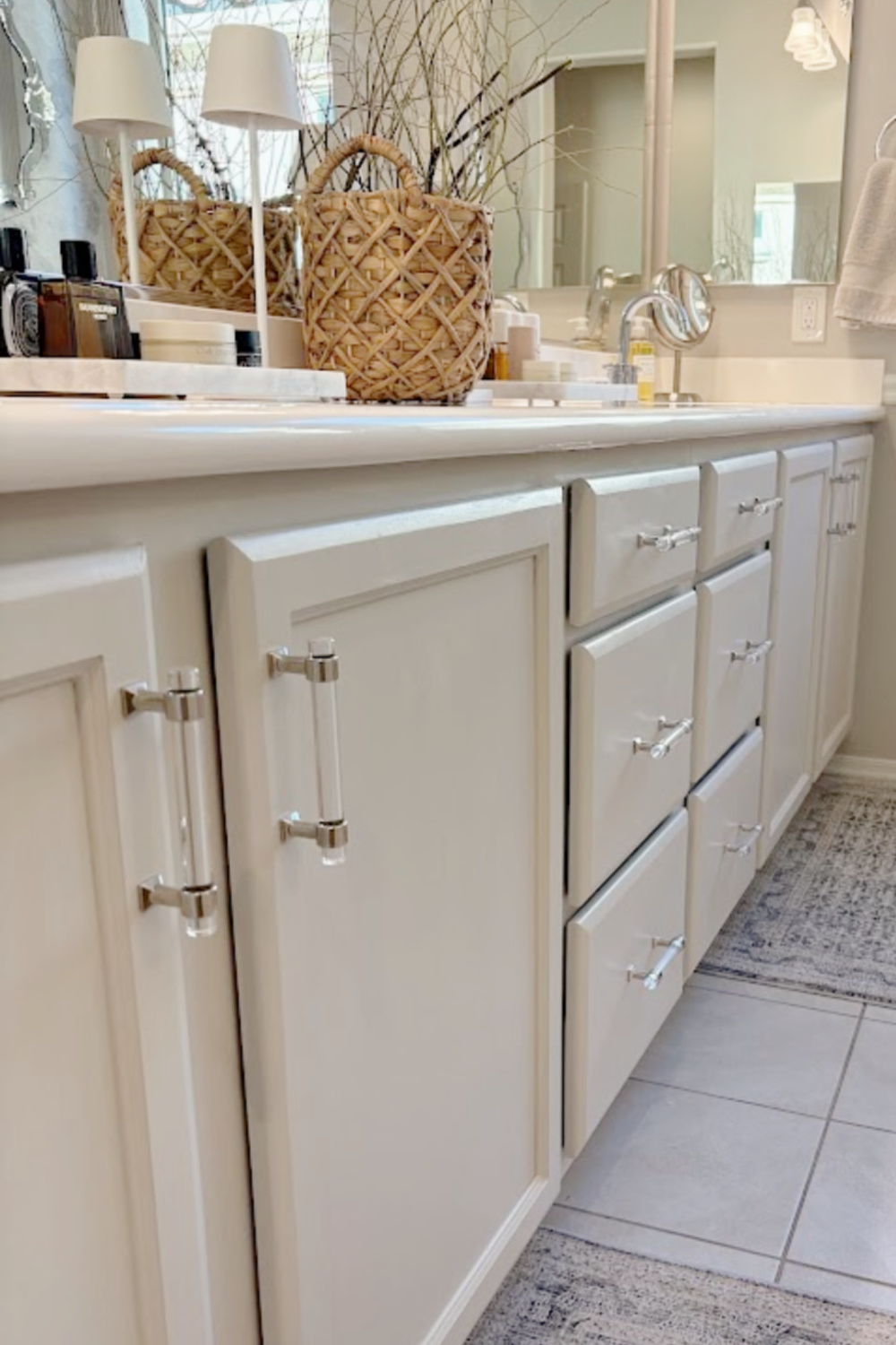 Our renovated bath at the snowbird Arizona house with SW Agreeable Gray painted vanity, lucite hardware, Venetian mirrors layered on a Photowall mural wallpaper, and rugs from Loloi x Amber Lewis - Hello Lovely Studio.