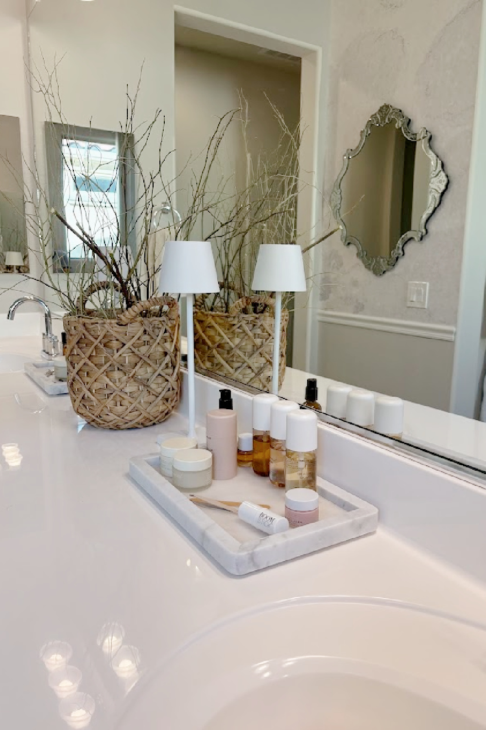 Our renovated bath at the snowbird Arizona house with SW Agreeable Gray painted vanity, lucite hardware, Venetian mirrors layered on a Photowall mural wallpaper, and rugs from Loloi x Amber Lewis - Hello Lovely Studio.