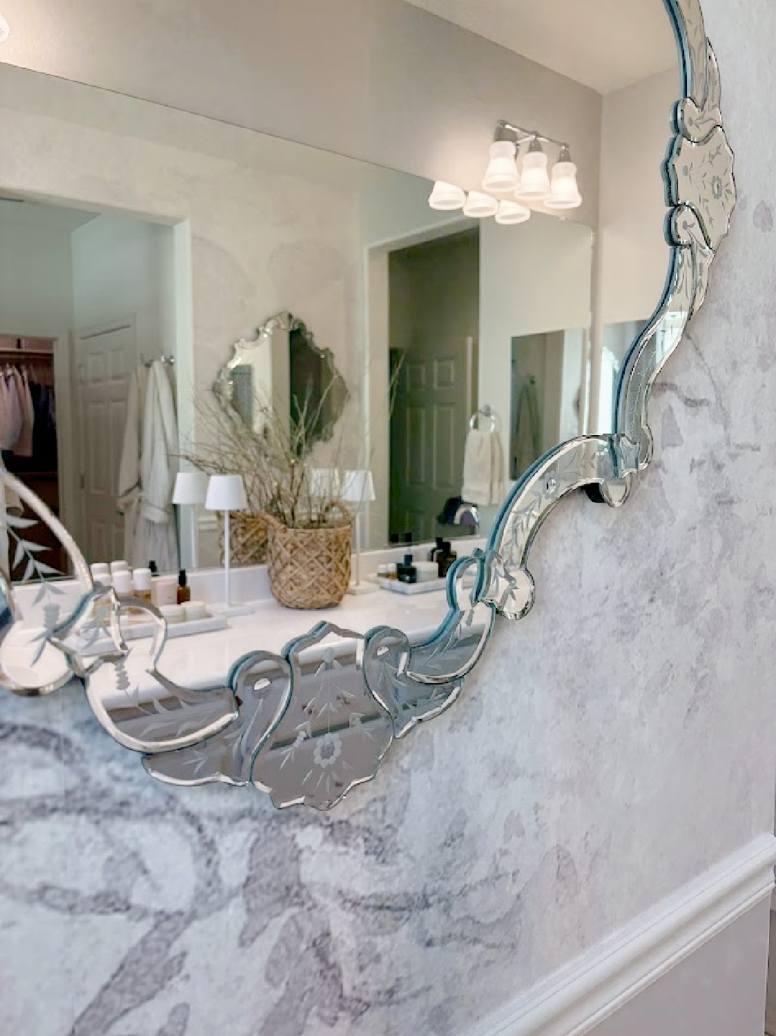 Our renovated bath at the snowbird Arizona house with SW Agreeable Gray painted vanity, lucite hardware, Venetian mirrors layered on a Photowall mural wallpaper, and rugs from Loloi x Amber Lewis - Hello Lovely Studio.
