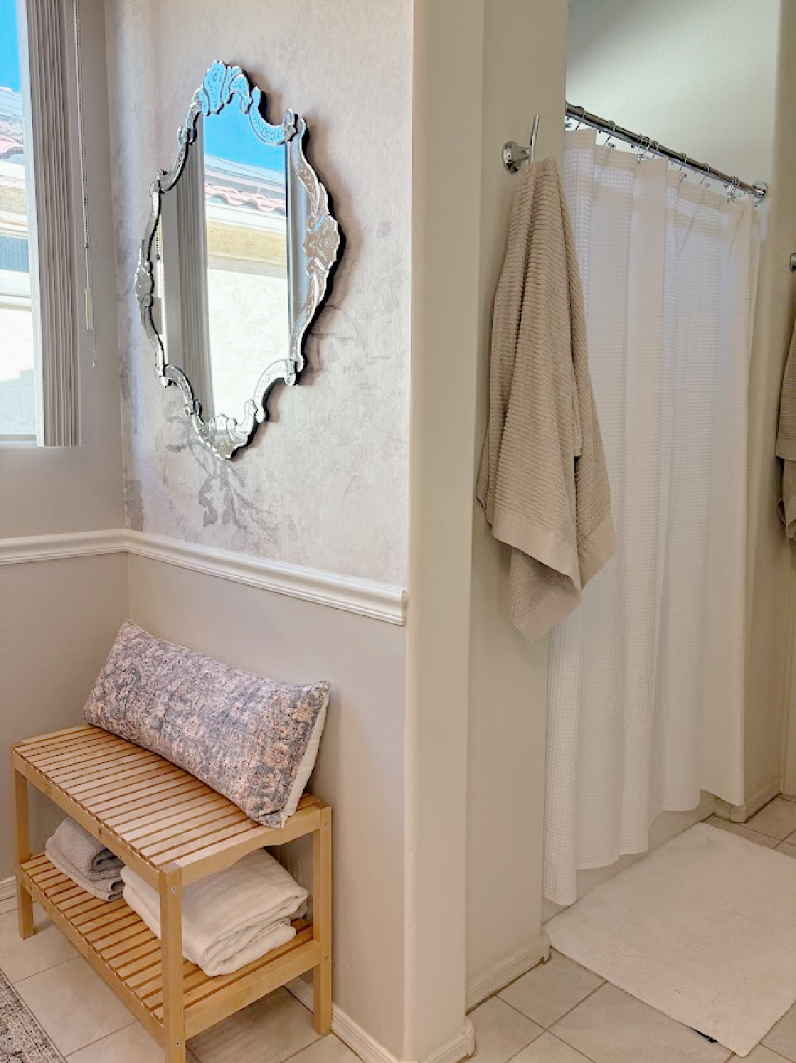 Our renovated bath at the snowbird Arizona house with SW Agreeable Gray painted vanity, lucite hardware, Venetian mirrors layered on a Photowall mural wallpaper, and rugs from Loloi x Amber Lewis - Hello Lovely Studio.
