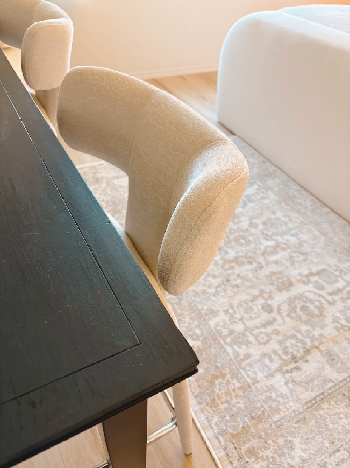 Beige modern upholstered counterstools at black console table I painted Farrow & Ball Railings - Hello Lovely Studio.