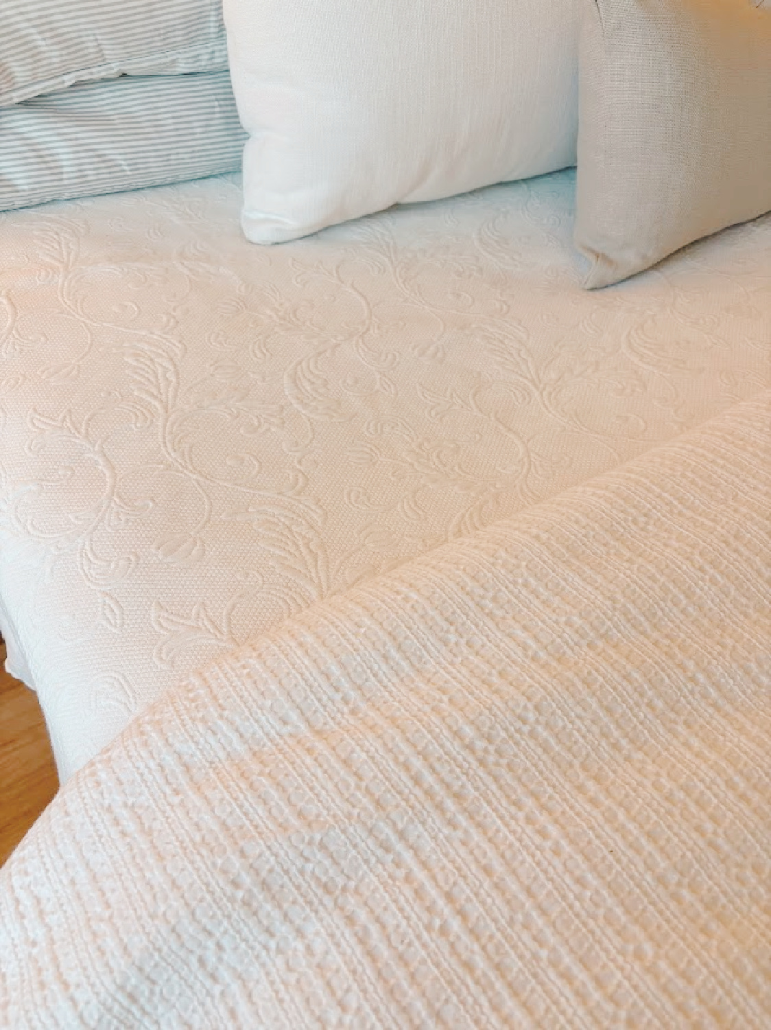 Detail of white coverlet and waffle duvety cover on my bed - Hello Lovely Studio.