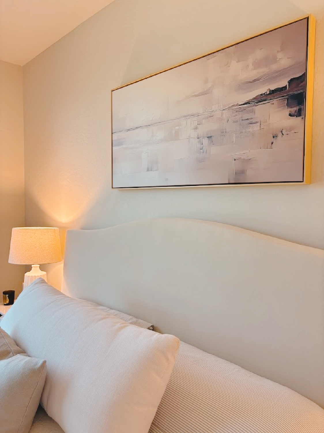 Sherwin Williams NATURAL CHOICE paint on walls in serene ivory bedroom with black nightstands and white linen - Hello Lovely Studio.