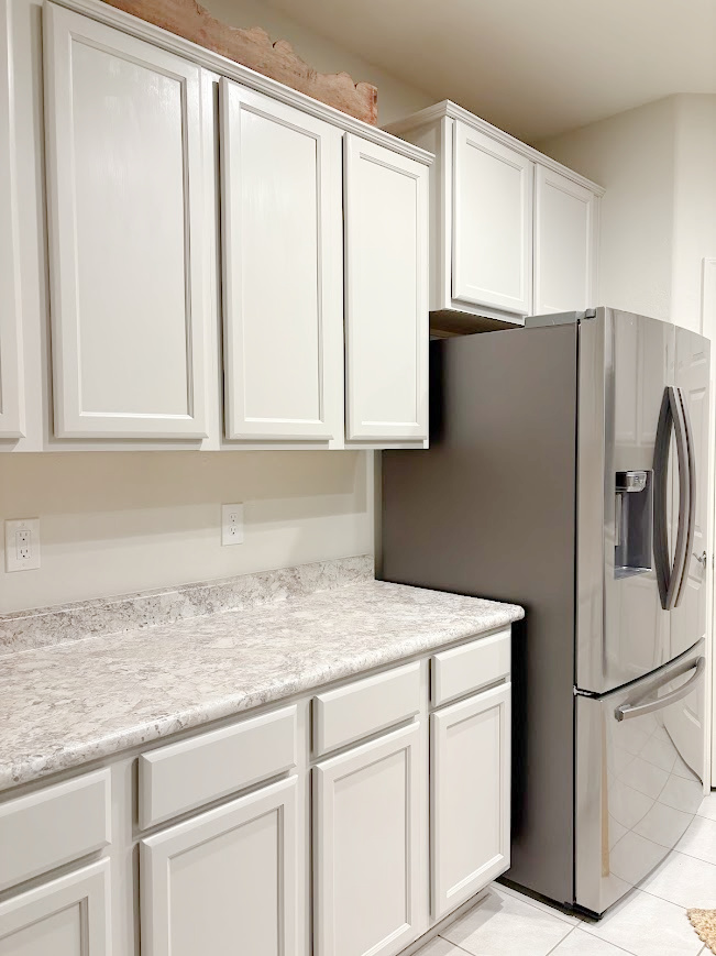 Sherwin-Williams Agreeable Gray on kitchen cabinets in our Arizona snowbird home - Hello Lovely Studio.