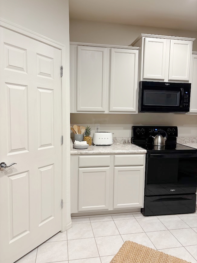 Sherwin-Williams Agreeable Gray on kitchen cabinets in our Arizona snowbird home - Hello Lovely Studio.