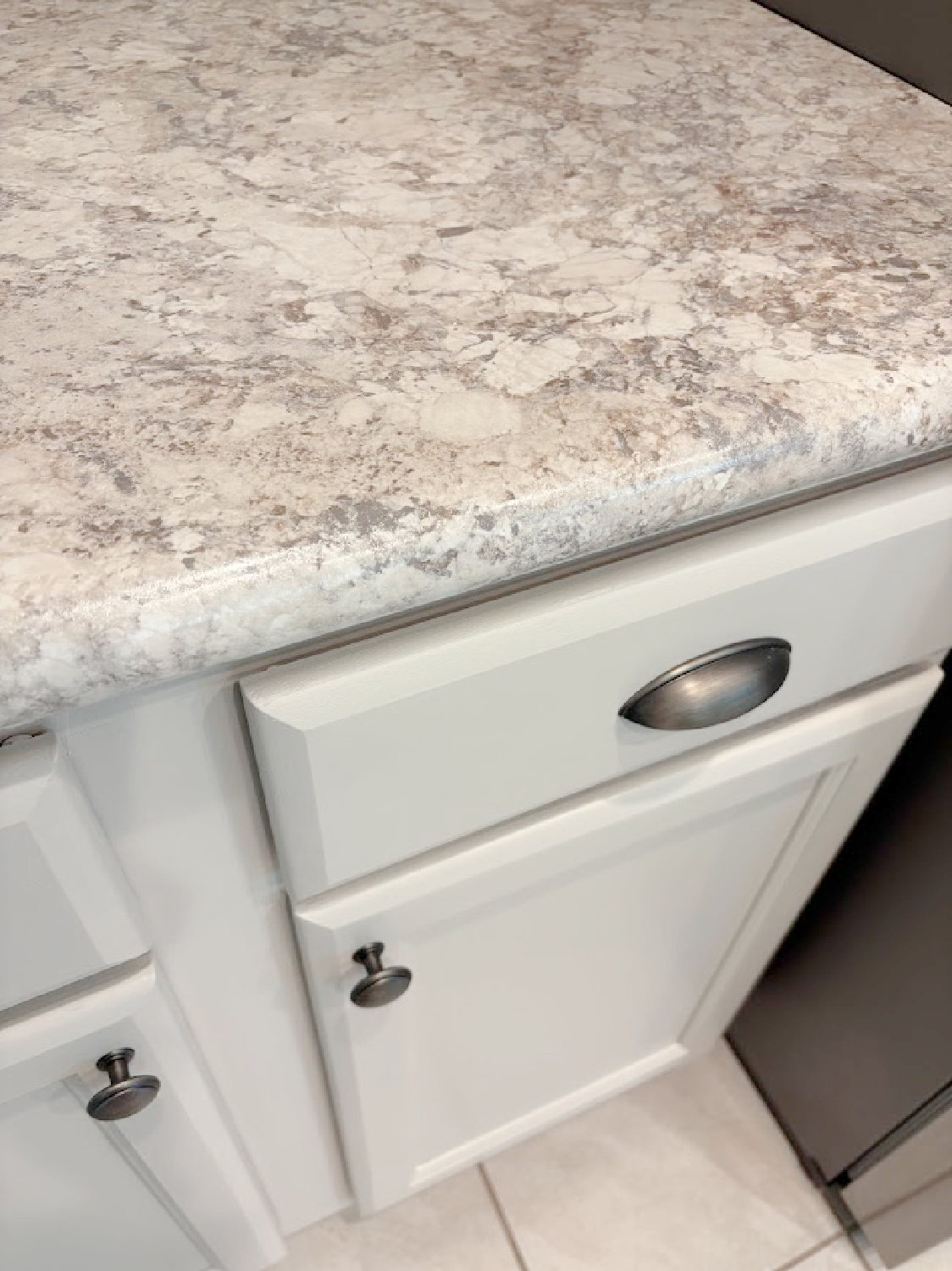 Sherwin-Williams Agreeable Gray on kitchen cabinets in our Arizona snowbird home - Hello Lovely Studio.