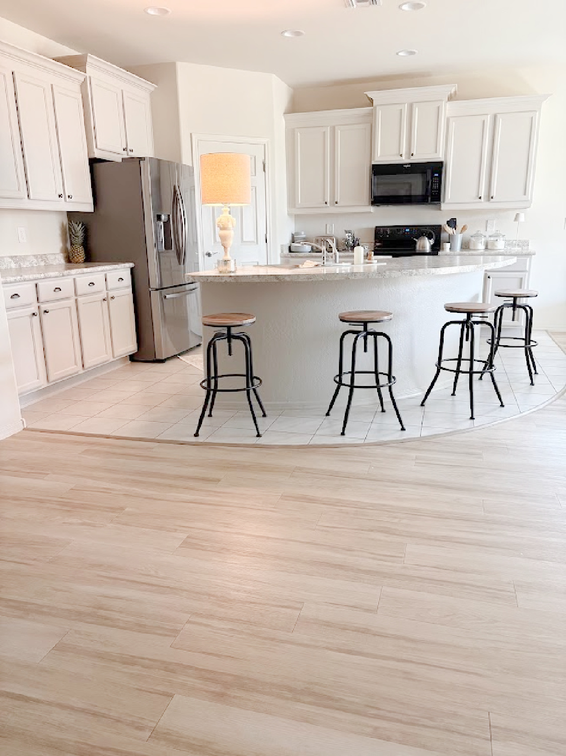 Arizona snowbird kitchen with curved breakfast bar with painted kitchen cabinets SW Agreeable Gray - Hello Lovely Studio.