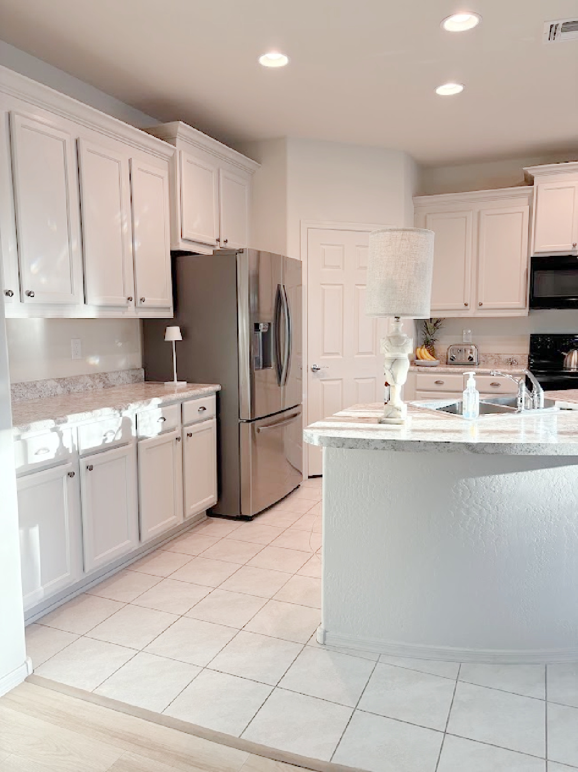 Arizona snowbird kitchen with curved breakfast bar with painted kitchen cabinets SW Agreeable Gray - Hello Lovely Studio.