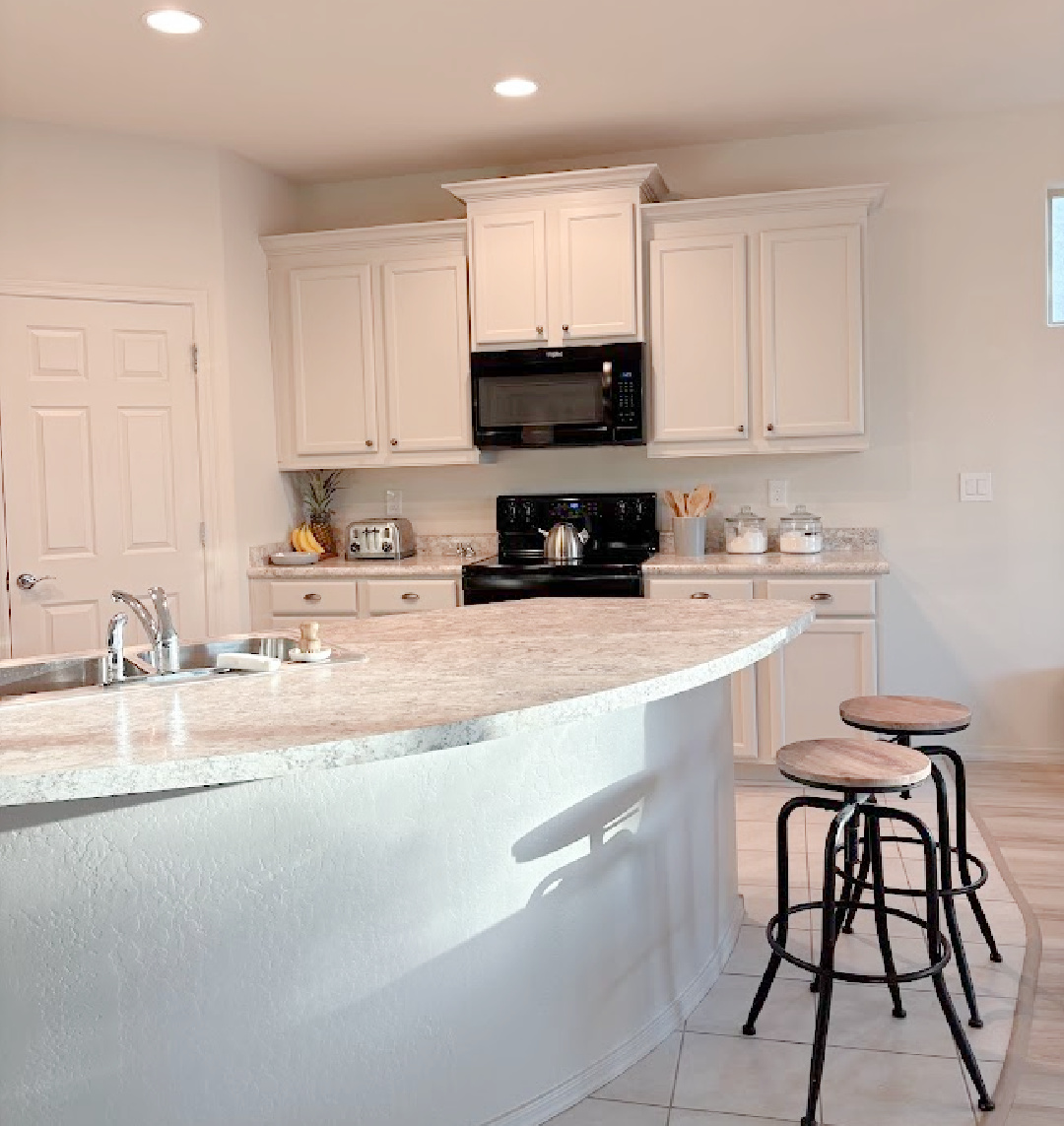 Arizona snowbird kitchen with curved breakfast bar with painted kitchen cabinets SW Agreeable Gray - Hello Lovely Studio.