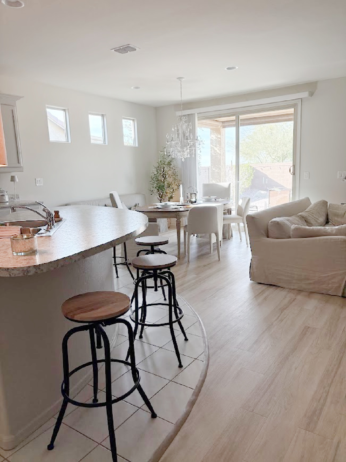 Curved breakfast bar with industrial stools in our Arizona snowbird home where we are adding custom touches - Hello Lovely Studio.