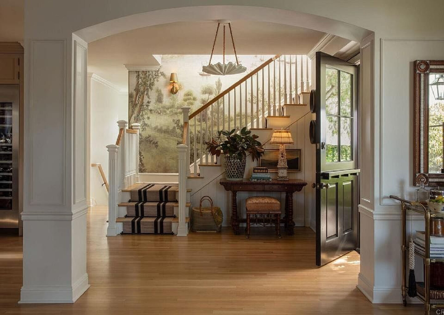 Breathtaking entry with mural and Dutch door in Leslie Martin's stunning traditional coastal home 5735 Dolphin in La Jolla, CA with interiors by M+M Interior Design. Offered by @nelsonbrothersrealestate