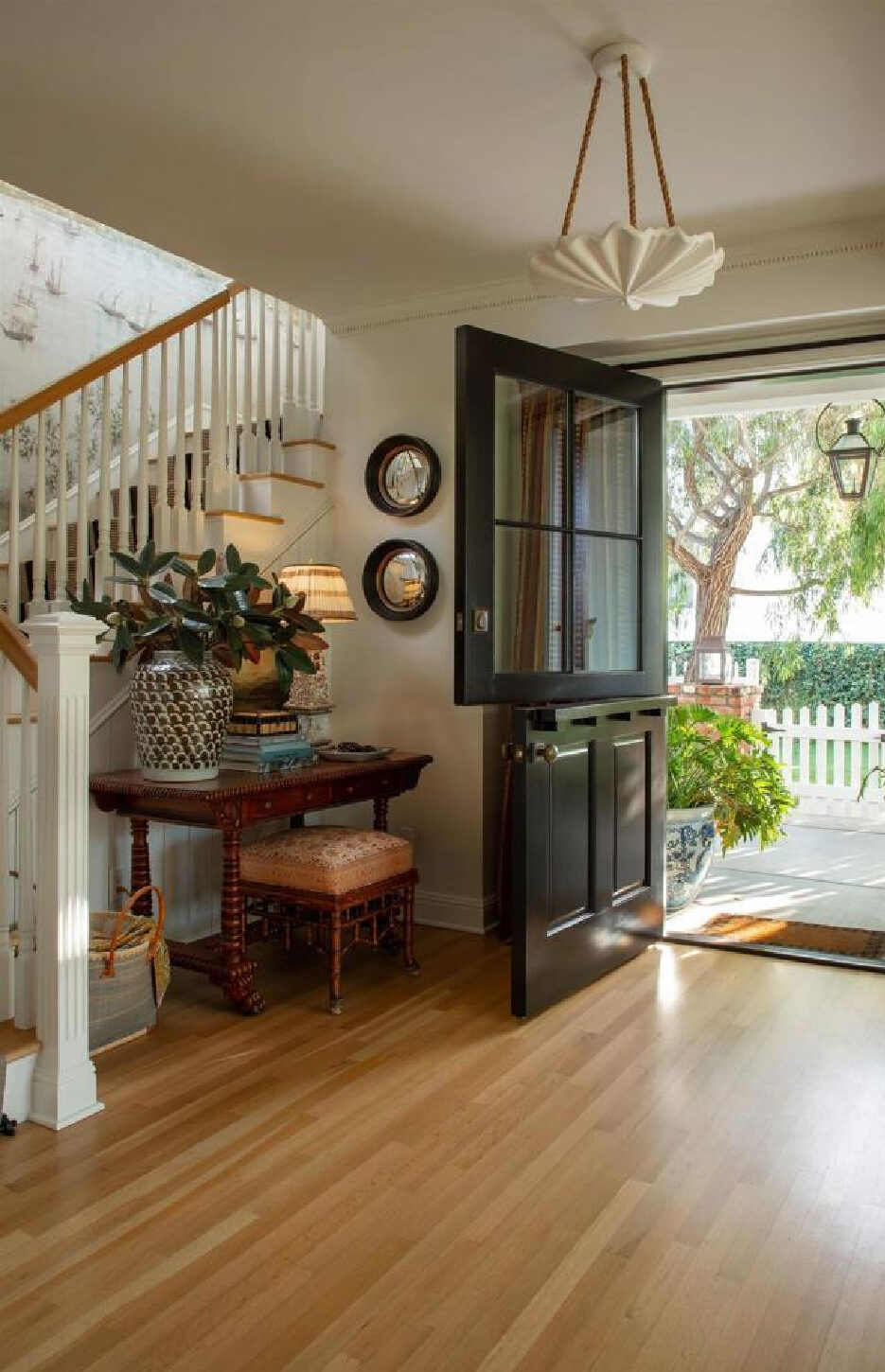 Breathtaking entry with mural and Dutch door in Leslie Martin's stunning traditional coastal home 5735 Dolphin in La Jolla, CA with interiors by M+M Interior Design. Offered by @nelsonbrothersrealestate