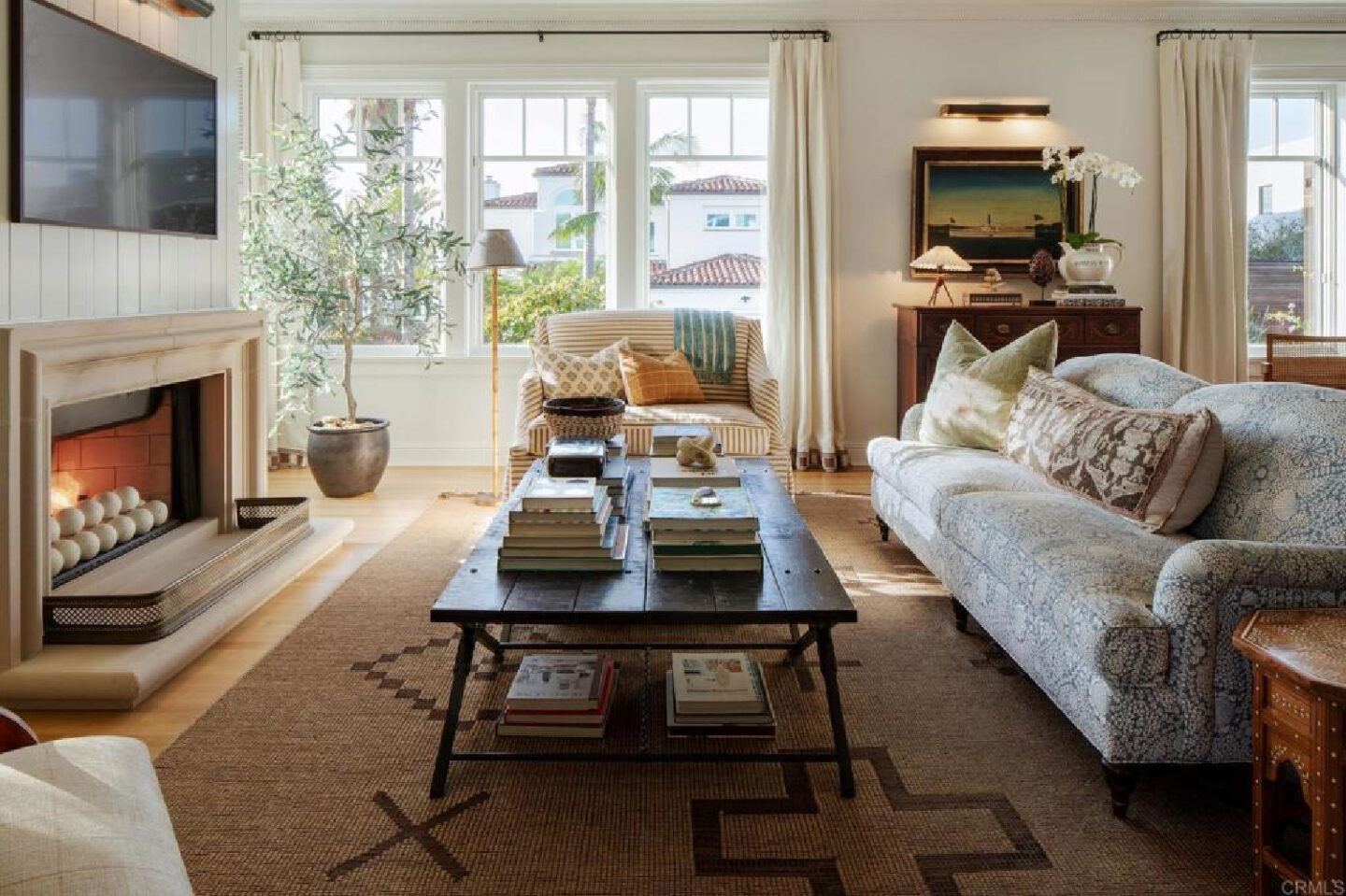 Coffee table with books in Leslie Martin's stunning traditional coastal home 5735 Dolphin in La Jolla, CA with interiors by M+M Interior Design. Offered by @nelsonbrothersrealestate