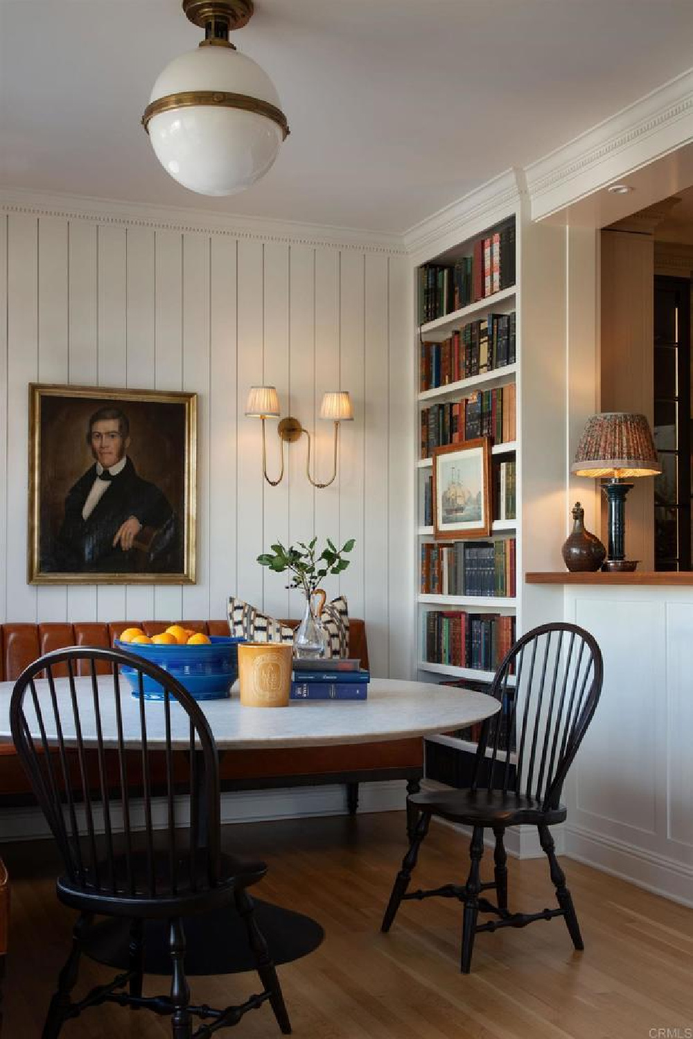 Hamptons style dining room with built-in bookshelves and banquette in Leslie Martin's stunning traditional coastal home 5735 Dolphin in La Jolla, CA with interiors by M+M Interior Design. Offered by @nelsonbrothersrealestate