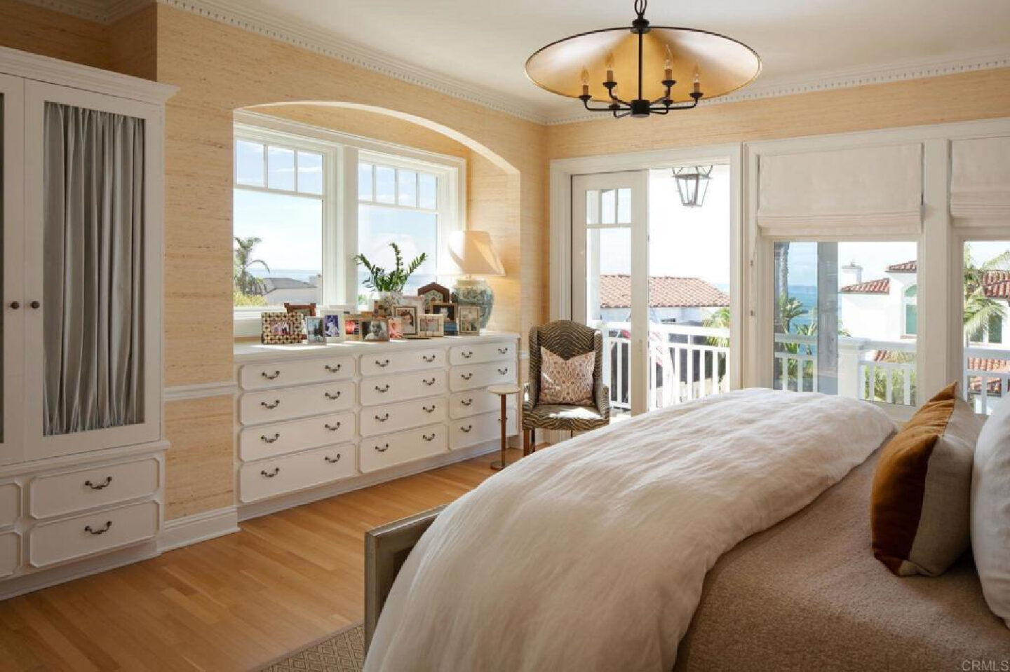 Primary bedroom with arched bay in Leslie Martin's stunning traditional coastal home 5735 Dolphin in La Jolla, CA with interiors by M+M Interior Design. Offered by @nelsonbrothersrealestate