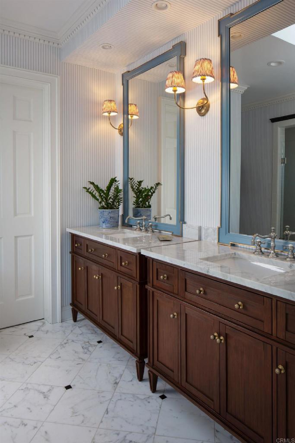 Vanity area with blue stripe wallpaper at stunning traditional coastal home 5735 Dolphin in La Jolla, CA with interiors by M+M Interior Design. Offered by @nelsonbrothersrealestate