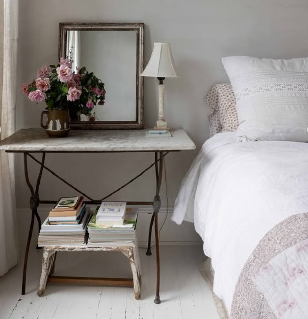 @redchair_hudson designed Swedish farmhouse style home with serene white bedroom with antique French side table - Lonny magazine.
