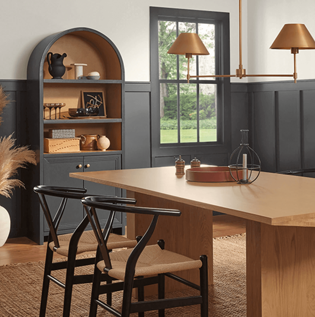 Sherwin Williams Iron Ore black paint color on paneling, door, and cabinet in dining room.