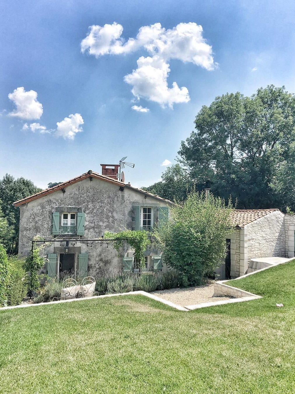 Green shutters (Tolix Green) on a rustic French farmhouse renovated by Vivi et Margot near Bordeaux.