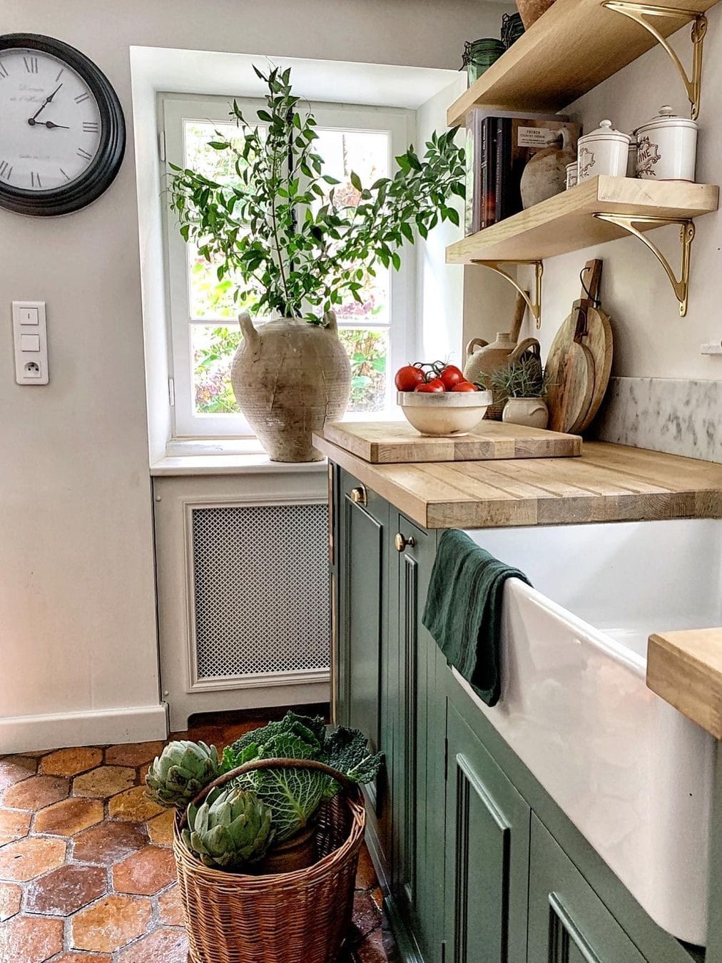 Vivi et Margot's beautiful French country kitchen with green cabinets (F&B Green Smoke) and antique terracotta tile floors.
