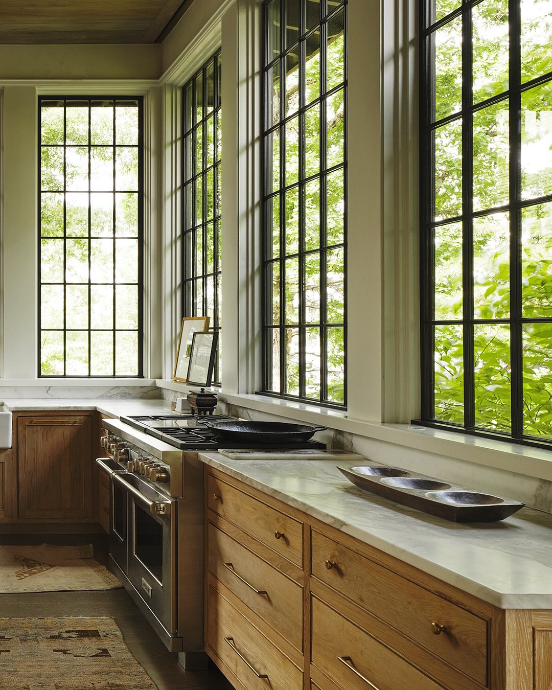 Jeffrey Dungan designed kitchen with tall windows to counter allowing nature inside - photo @a_gaut.