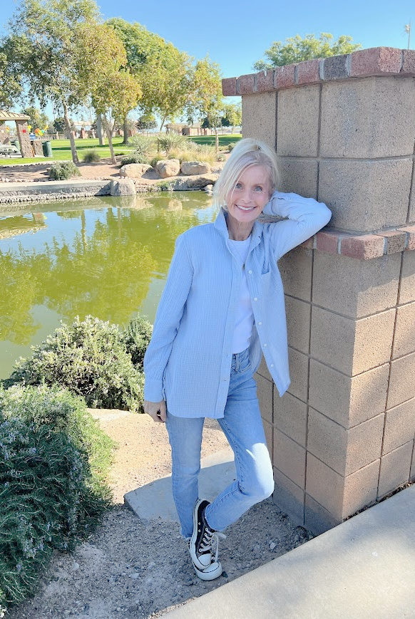 Michele of Hello Lovely Studio near pond in blue J. Crew button-down, J. Crew jeans, and J. Crew perfect tee.