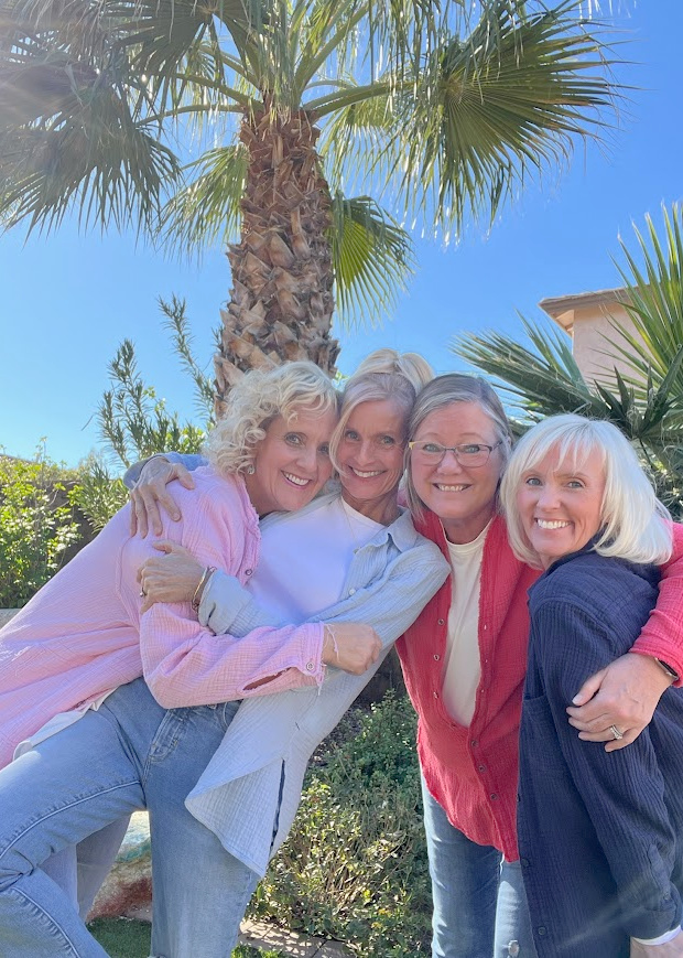 Michele of Hello Lovely Studio with her friend and two sisters under the palms in sister's backyard.
