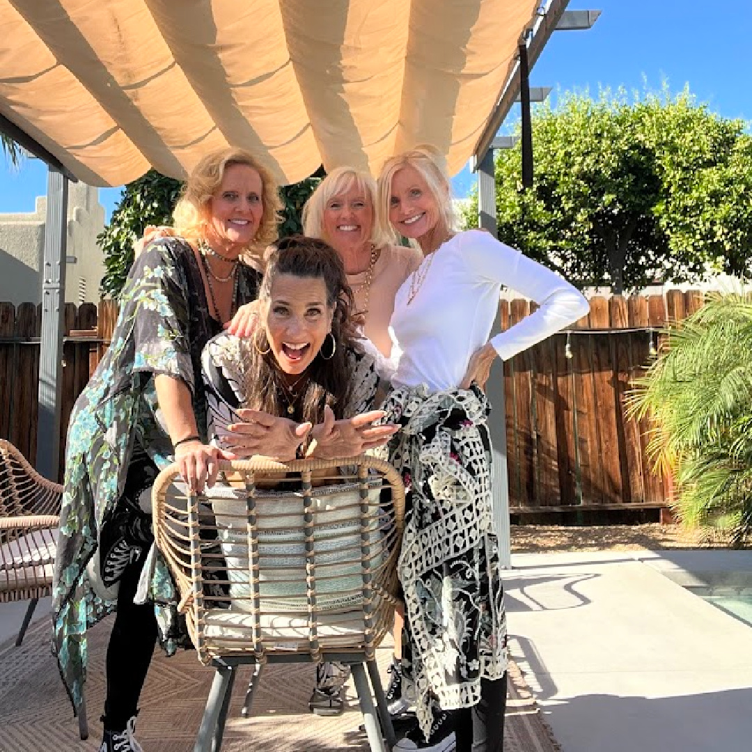 Michele of Hello Lovely Studio with friends under a tropical canopy.