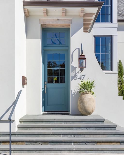 Bevolo outdoor light at a lovely elegant white stucco entrance.