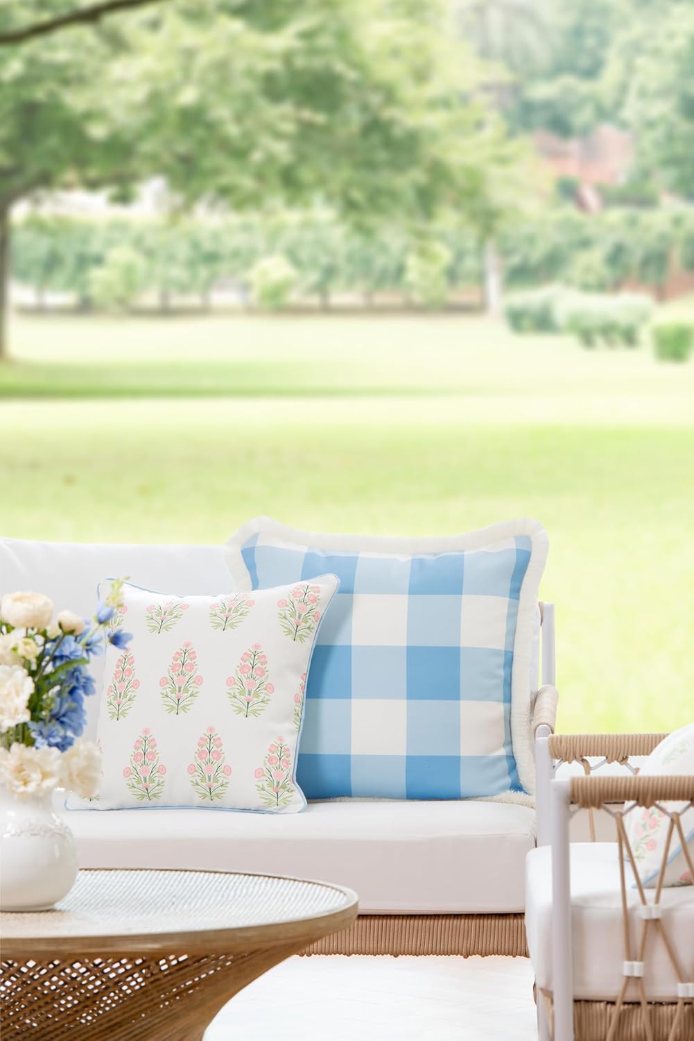 Pretty pink and green throw pillow and Buffalo cheks on a coastal style patio sofa, Hofdeco.