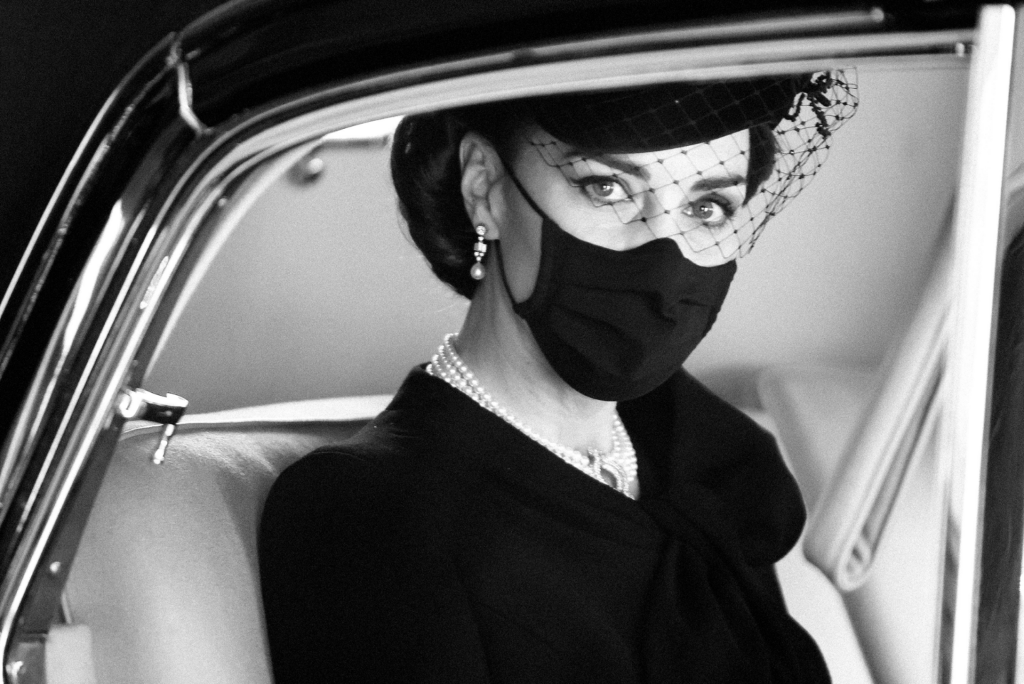 Princess Kate in black with mask and veiled hat - from MODERN MAJESTY (Rizzoli, 2026) by Chris Jackson.