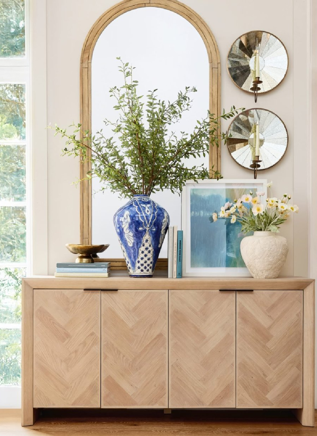 Sideboard with blue vase and mirrors from Pottery Barn's Spring Look Book for 2026.