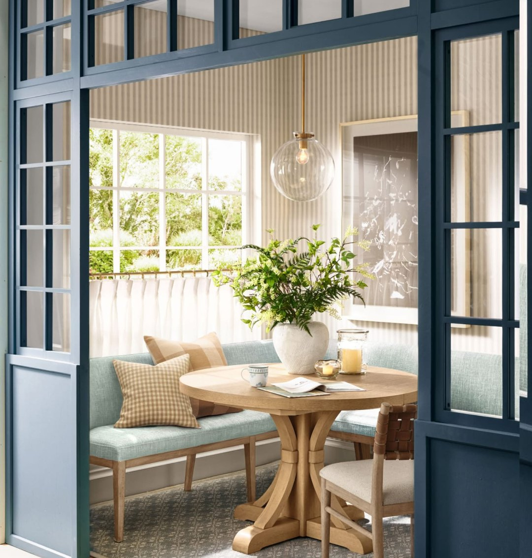 Charming navy blue millwork in breakfast dining room from Pottery Barn's Spring Look Book for 2026.