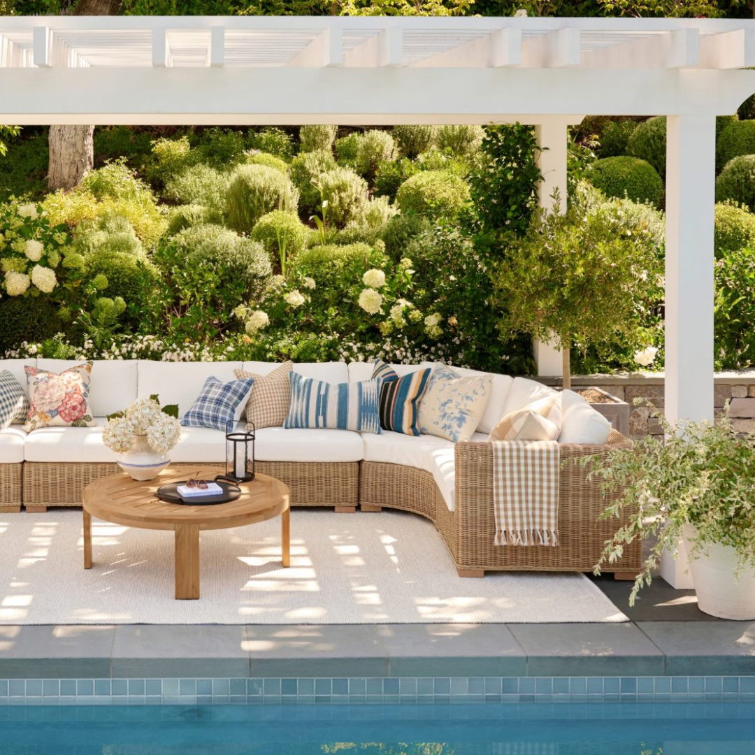 Outdoor sectional under pergola near pool from Pottery Barn's Spring Look Book for 2026.