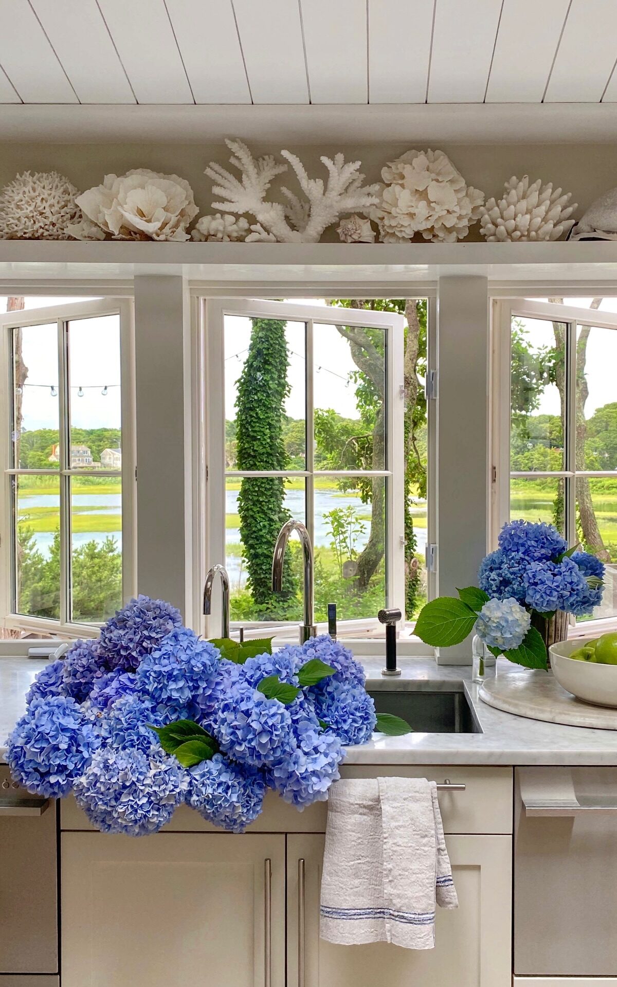 Blue hydrangea at kitchen sink - Old Silver Shed. #kennedycore #coastalkitchen
