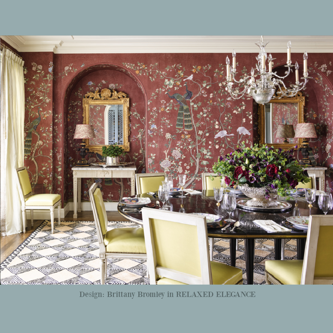 Chinoiserie chic handpainted wallpaper with burgundy in a dining room with classic design by Brittany Bromley in RELAXED ELEGANCE (Rizzoli, 2025).