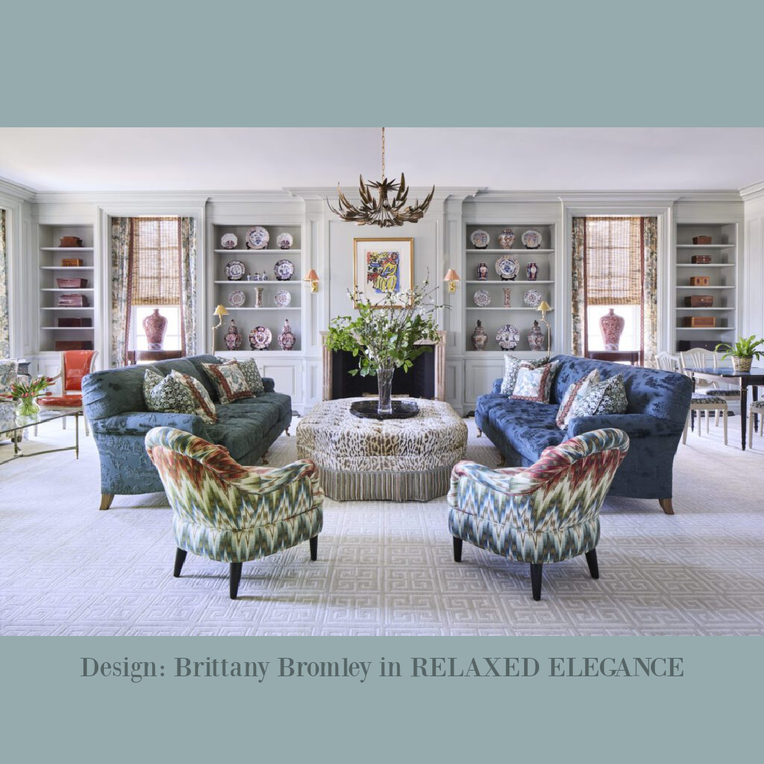 Wall of built-in bookshelves, navy Damask sofas, and classic design by Brittany Bromley in RELAXED ELEGANCE (Rizzoli, 2025).