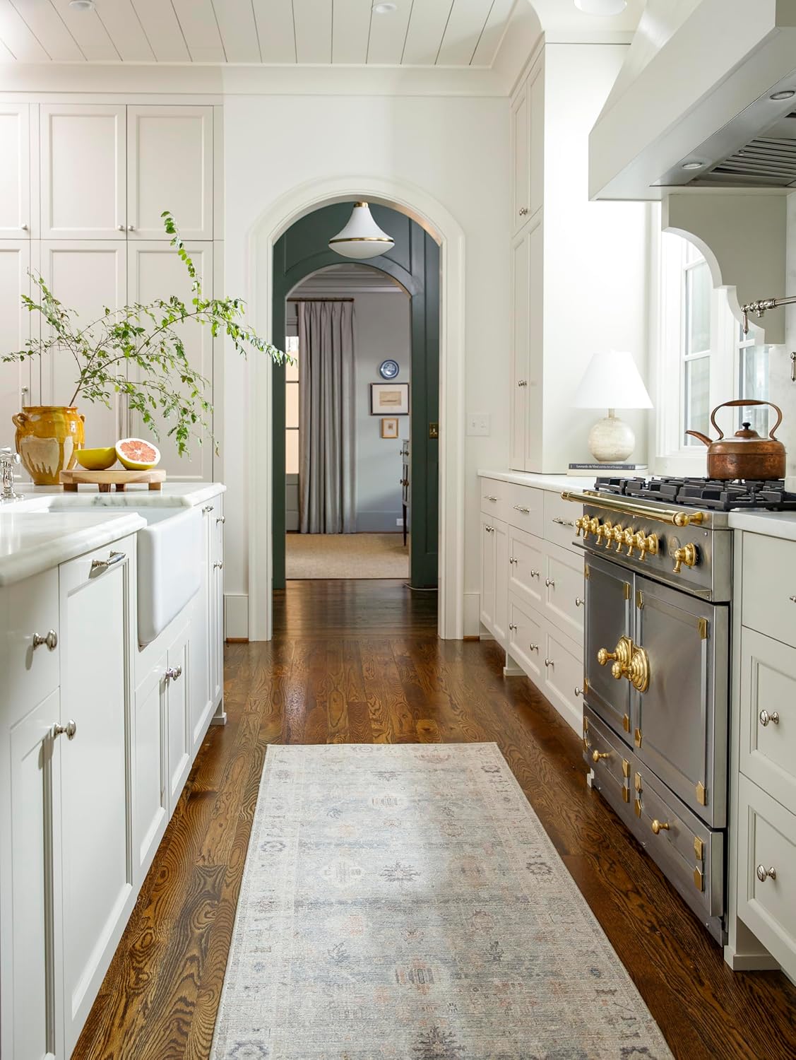 Becki Owens kitchen with  Benjamin Moore Chantilly Lace white paint and French range.