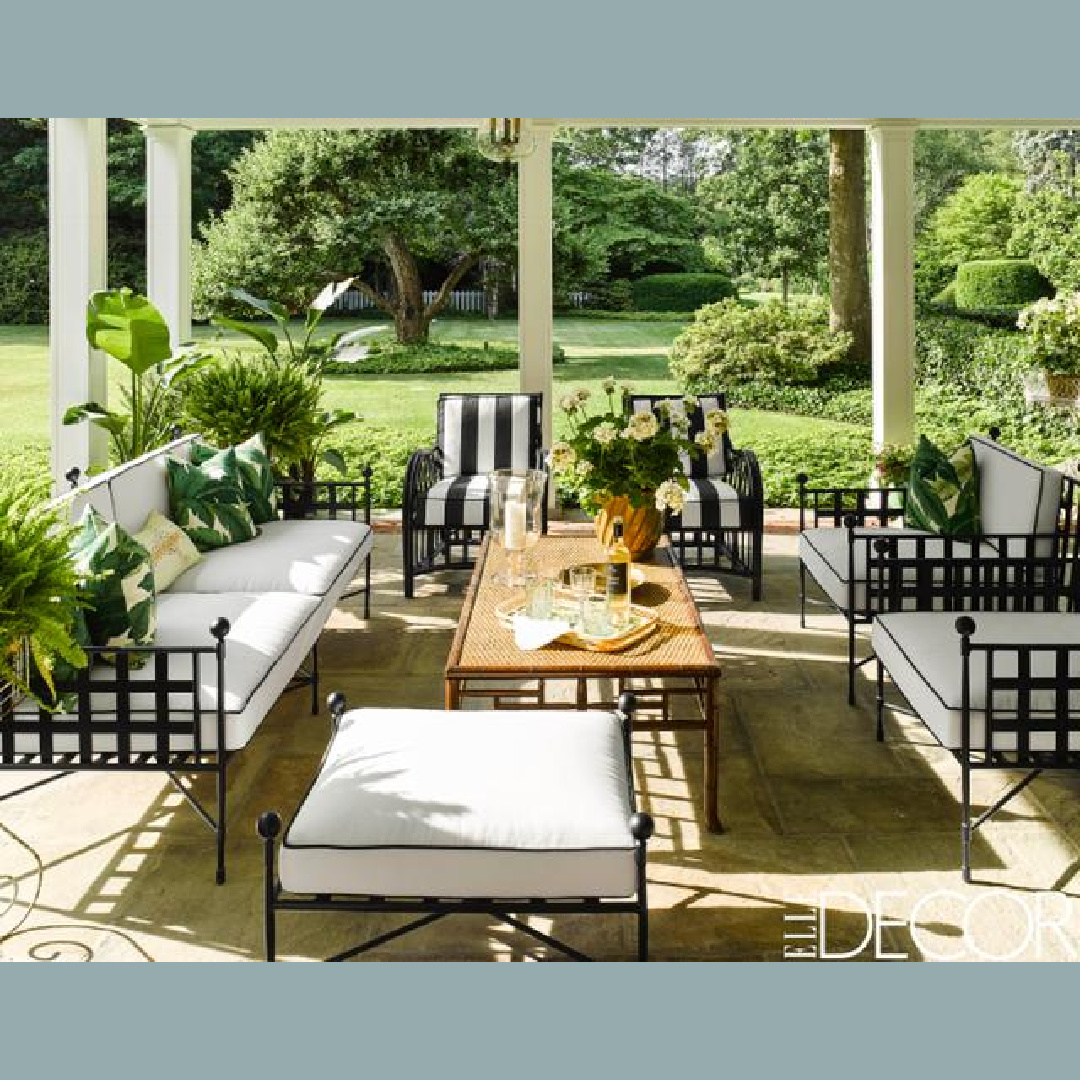 Pretty patio by Brittany Bromley with black and white stripes and banana leaves - Elle Decor.