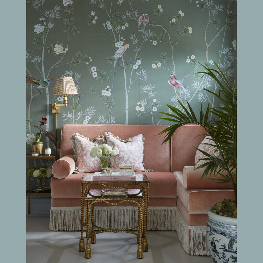 Gorgeous Chinoiserie handpainted wallpaper with teal in a sitting area with blush pink velvet seating with bolsters and swing arm wall sconce - Brittany Bromley.