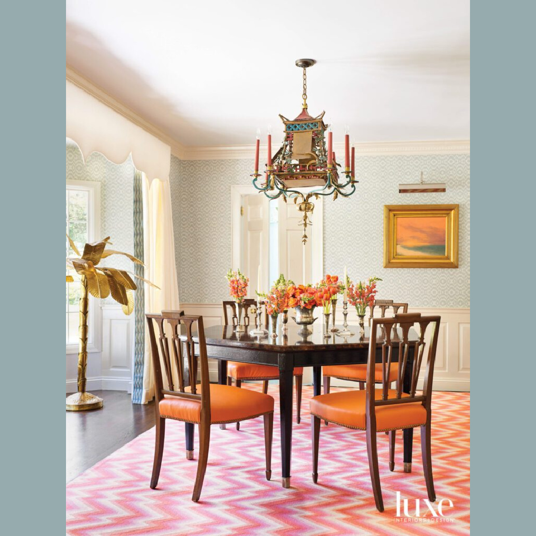Classic and elegant dining room with orange and magnificent pagoda chandelier - design by Brittany Bromley.