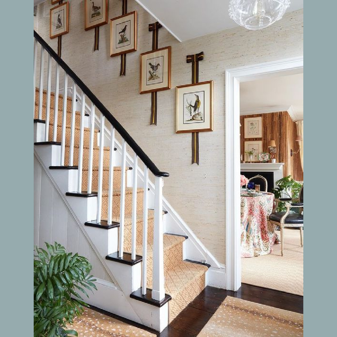 Brittany Bromley designed entry with staircase, grasscloth wallpaper, framed bird art, and classic elegance.