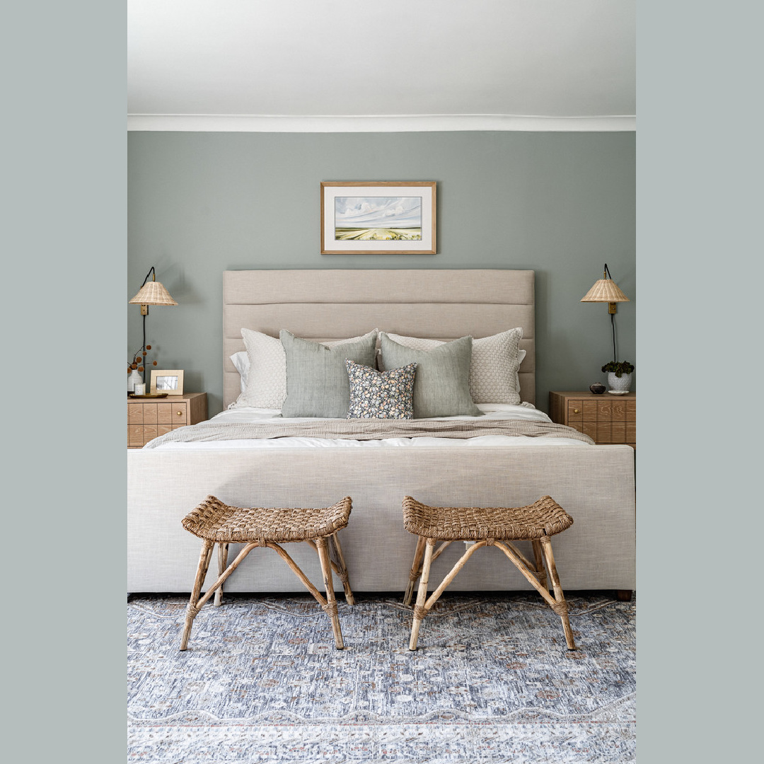 Carolin Friese - Farrow & Ball Green Blue 84 on walls of serene bedroom with upholstered bed.