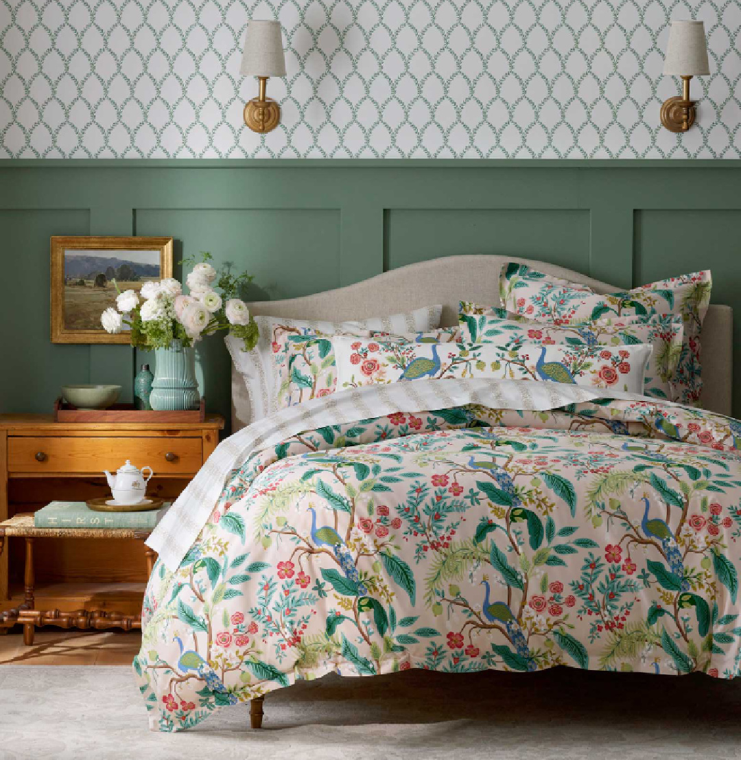 Beautiful green wainscot in bedroom with Peacock Blush bedding from Rifle Paper Co.