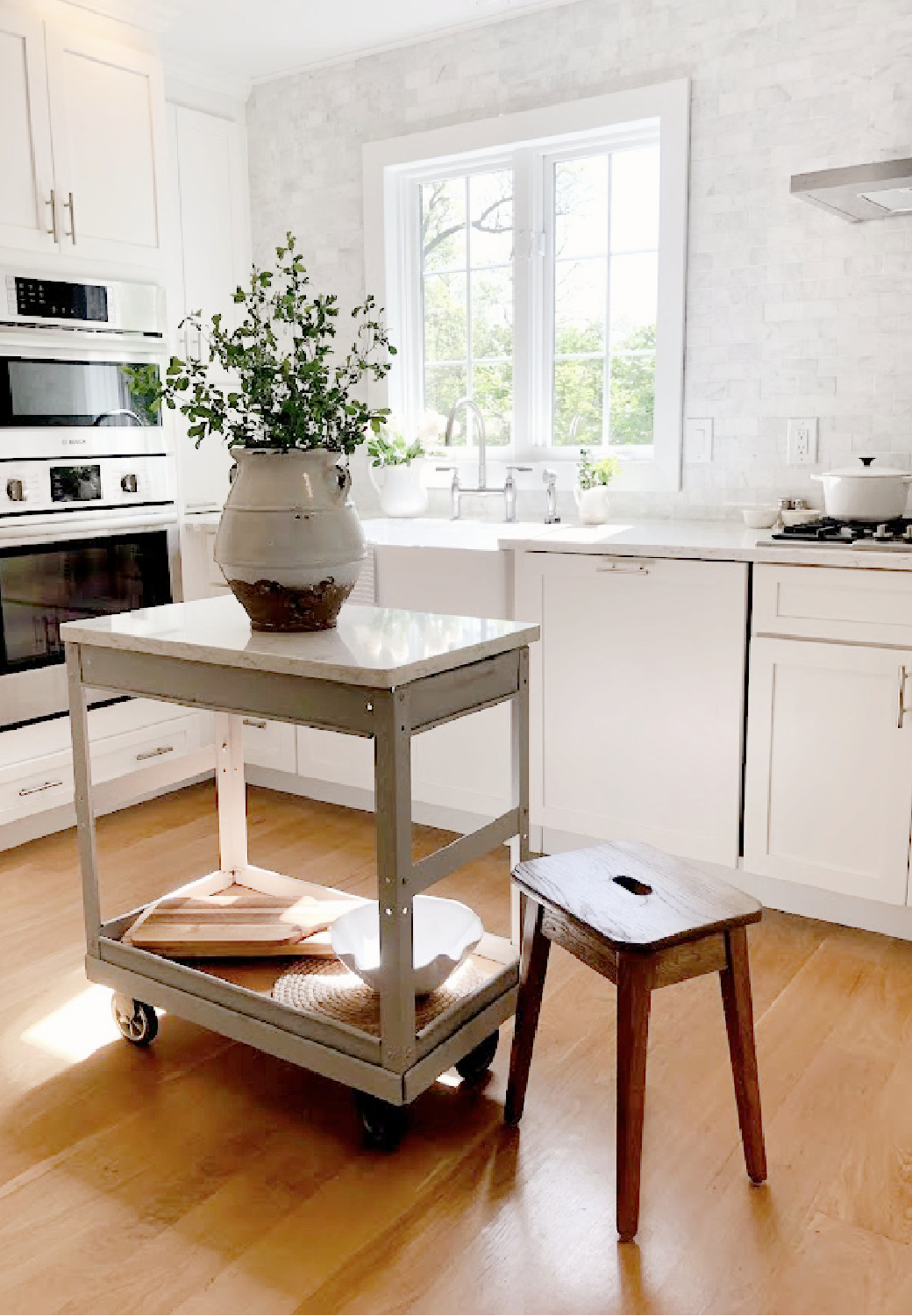 Hello Lovelys serene Shaker kitchen with industrial steel cart as work table topped with Viatera SOPRANO white quartz.
