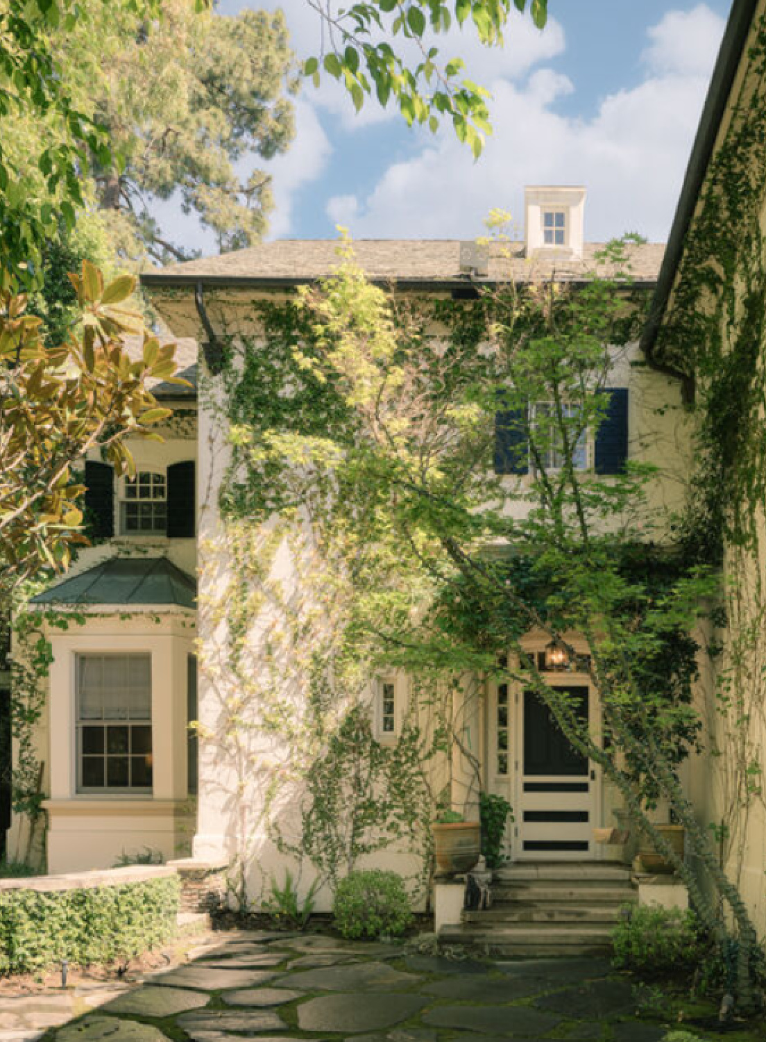Charming vines climbing a French country cottage style manse. Modern French interiors (Clements Design) in a Hidden Hills, CA storybook home with neutral decor and famous owners including Jennifer Lawrence, Jessica Simpson, and Ellen DeGeneres - Realtor.com
