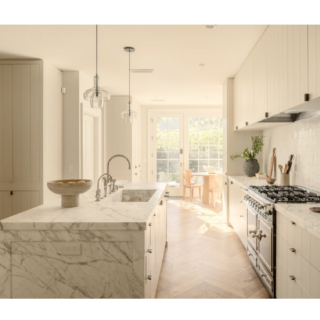 Modern minimal kitchen with marble island and putty tones (Clements Design) in a Hidden Hills, CA storybook home with neutral decor and famous occupants including Jennifer Lawrence, Jessica Simpson, and Ellen DeGeneres - Realtor.com